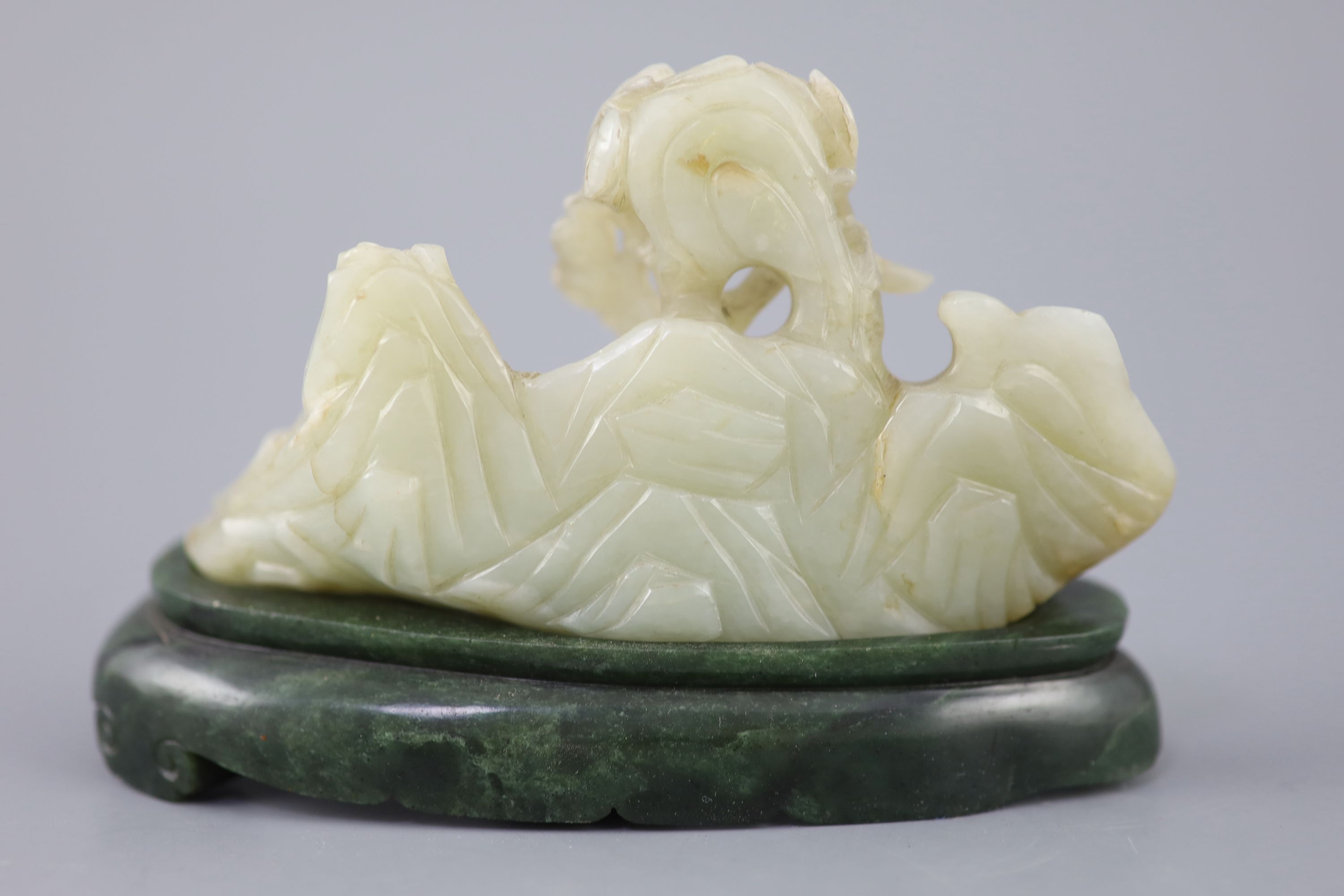 A Chinese pale celadon jade boulder carving, Qing dynasty, 13cm wide, the spinach green jade stand probably later